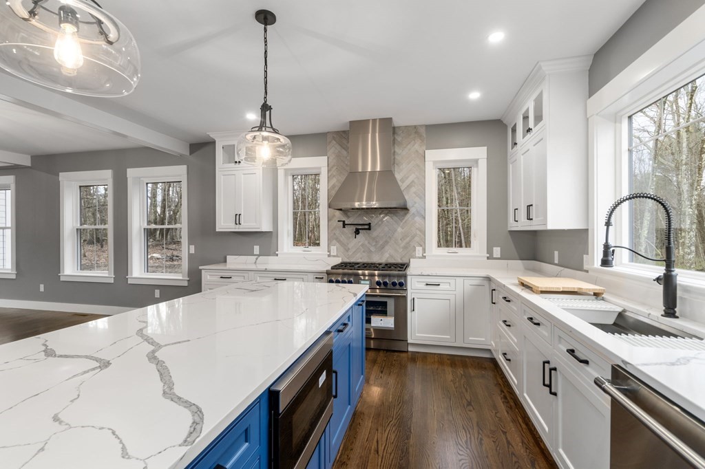 Custom kitchen with island and pendant lighting by Wingspan Properties