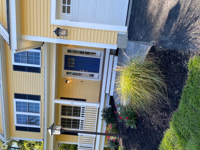 Home with a wrap-around front porch built by Wingspan Properties